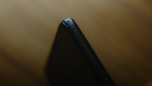 black smartphone on brown wooden table