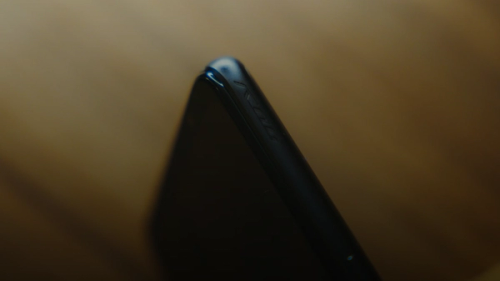 black smartphone on brown wooden table