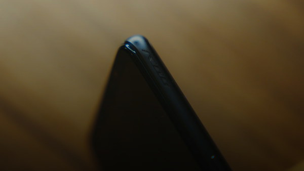 black smartphone on brown wooden table