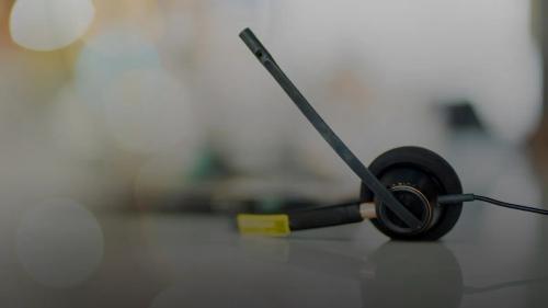 A pair of black headphones sitting on top of a table