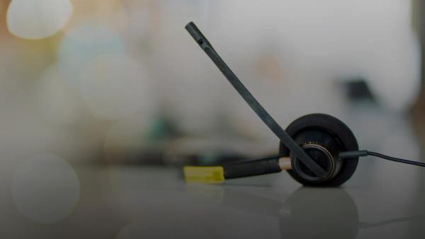 A pair of black headphones sitting on top of a table