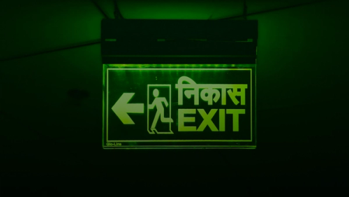 Green exit sign with arrow pointing left