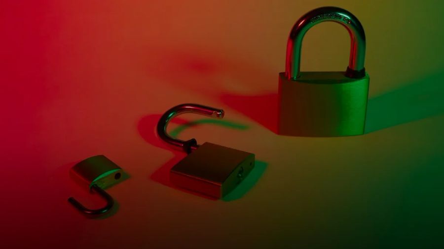 green and silver padlock on yellow surface
