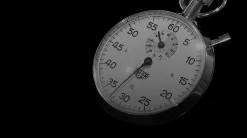 a close up of a stopwatch on a black background