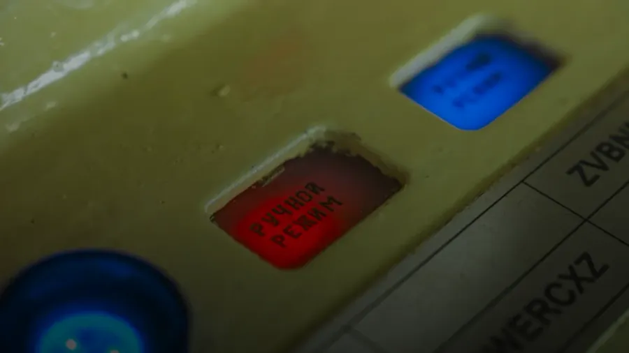 Red and blue buttons on a control panel.