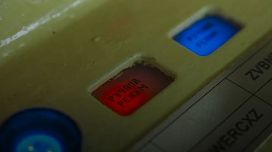 Red and blue buttons on a control panel.