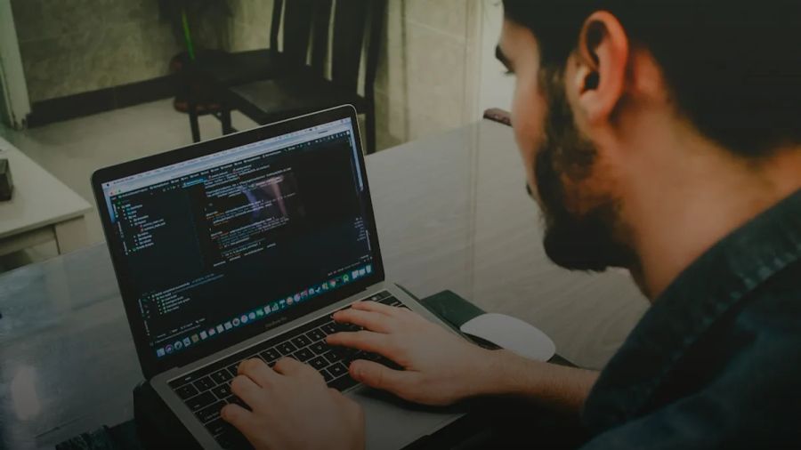 man programming using laptop
