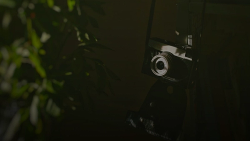 black and silver camera on black surface