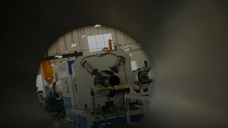 a machine in a factory with a man working on it