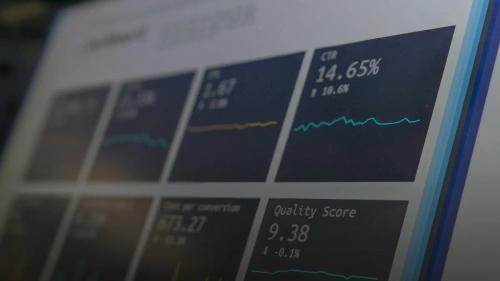 A digital dashboard displaying marketing metrics including CTR and quality score on a screen