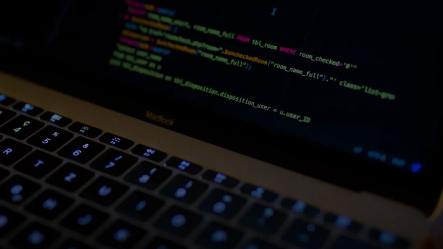 MacBook Pro with images of computer language codes