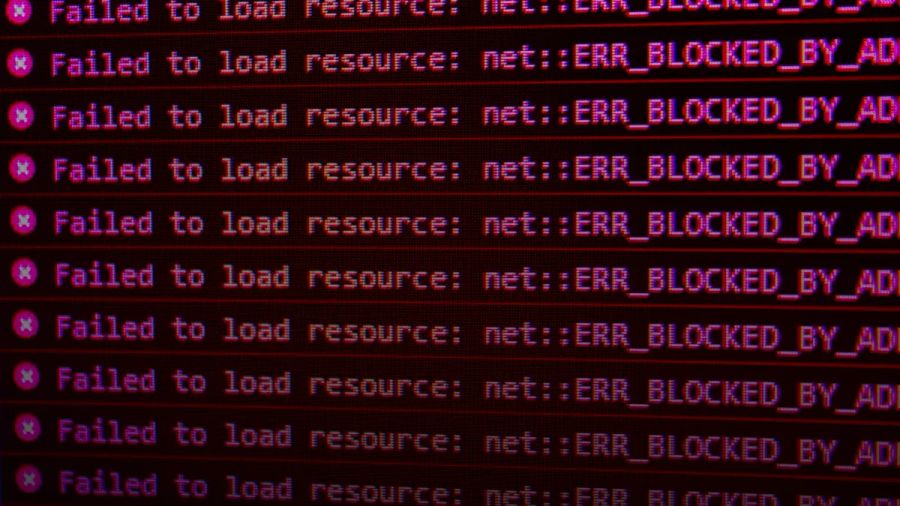 Red error messages on a black computer screen indicating blocked web resources