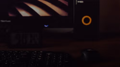 a computer keyboard and mouse on a desk