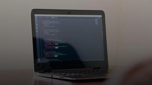 turned-on laptop with computer programming codes display