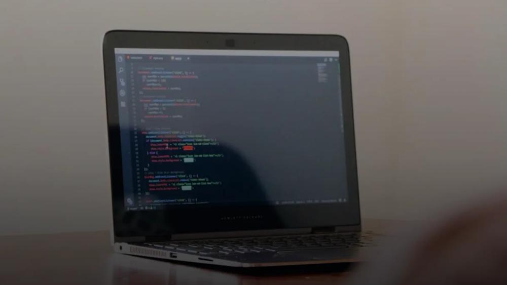 turned-on laptop with computer programming codes display