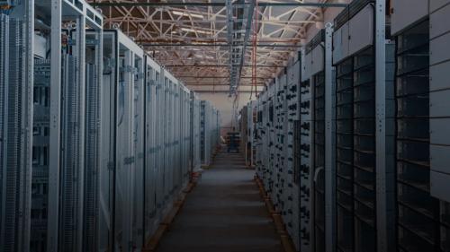 server room aisle with metal equipment racks