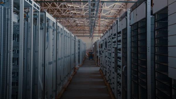 server room aisle with metal equipment racks