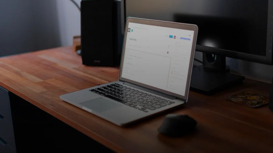 macbook pro on brown wooden table