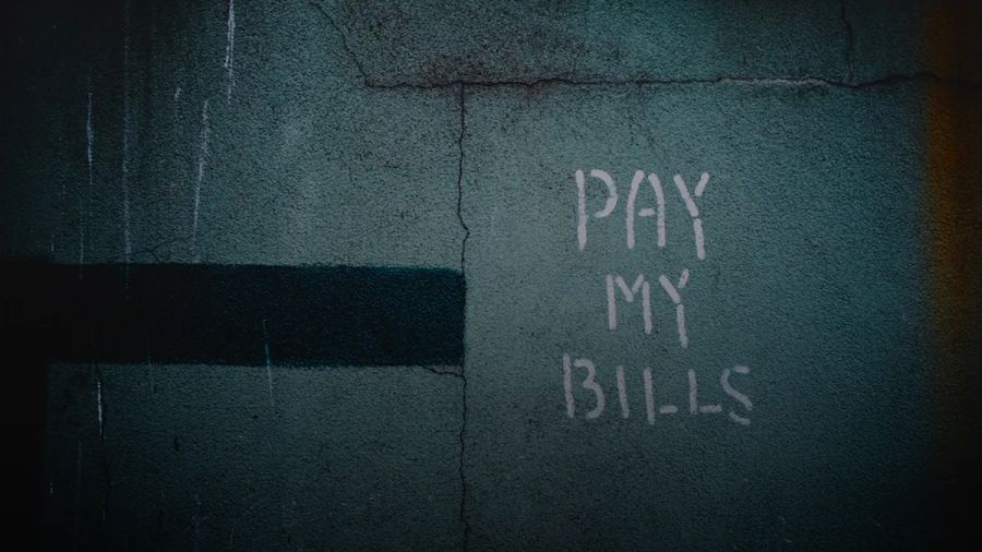 shallow focus photo of wall with pay my bills paint