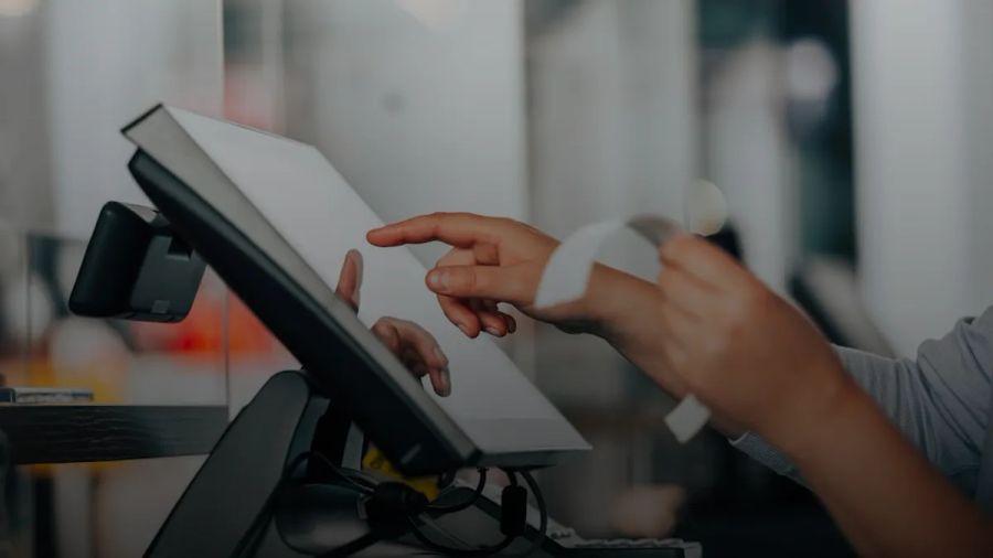a person is using a pos machine in a store