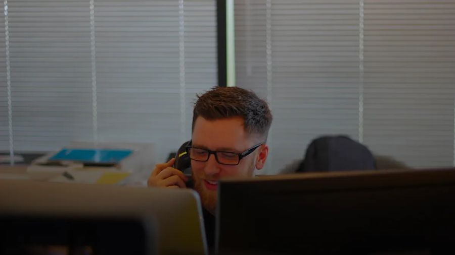 man using IP phone inside room