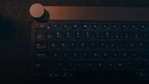 A computer keyboard sitting on top of a table