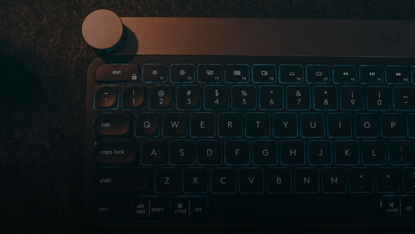 A computer keyboard sitting on top of a table