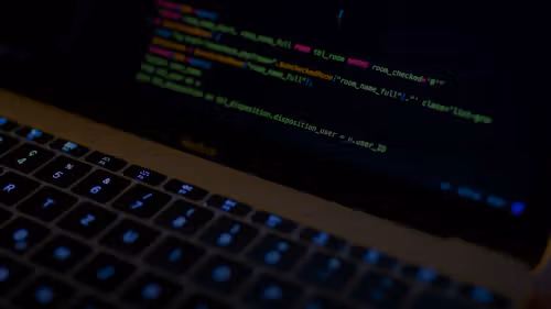 MacBook Pro with images of computer language codes