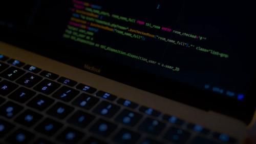 MacBook Pro with images of computer language codes