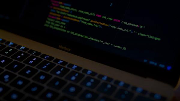 MacBook Pro with images of computer language codes