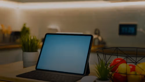 A tablet sits on a kitchen counter.