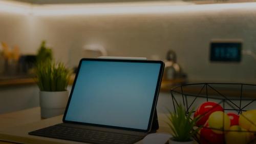 A tablet sits on a kitchen counter.