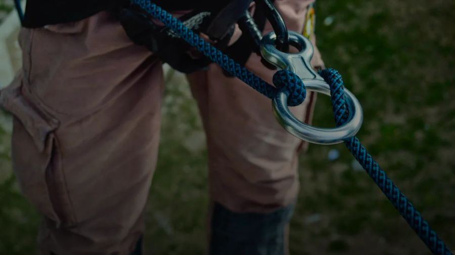 person with blue safety harness on focus photo