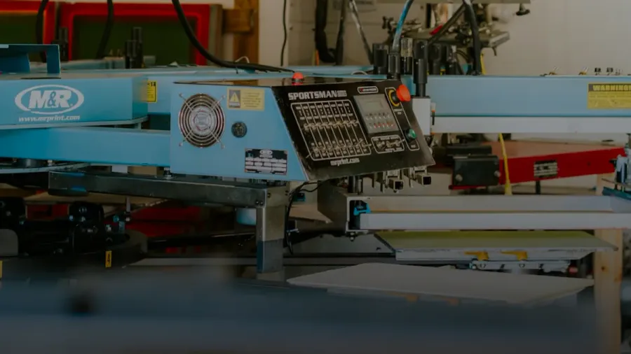 Industrial screen printing machine in a workshop setting