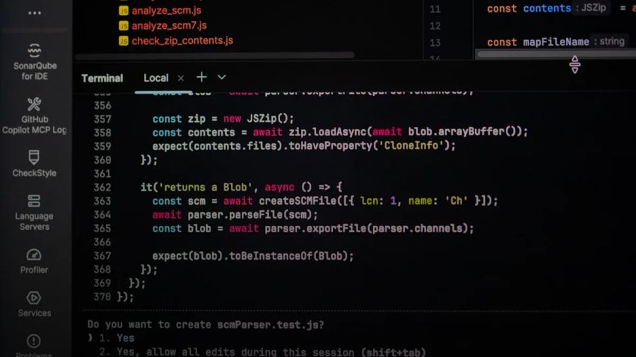 Coding on a dark theme computer screen