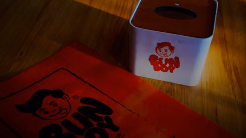 Bun boy branding on orange paper and tissue box