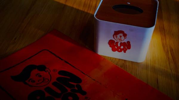 Bun boy branding on orange paper and tissue box