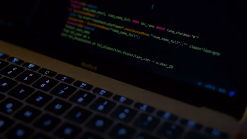 MacBook Pro with images of computer language codes