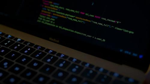 MacBook Pro with images of computer language codes