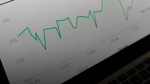 stock market chart displayed on laptop screen