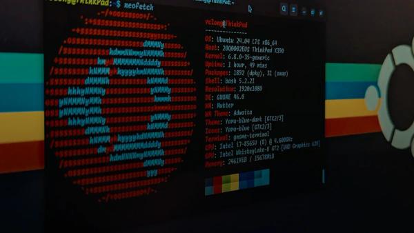 A computer screen displaying system information and an Ubuntu logo in a terminal window