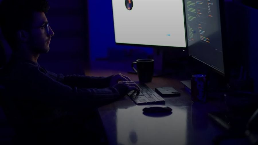 a man sitting at a desk in front of a computer