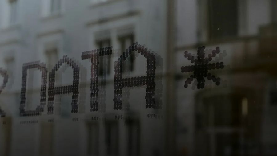 The word DATA and a star symbol stenciled in dark dots on glass