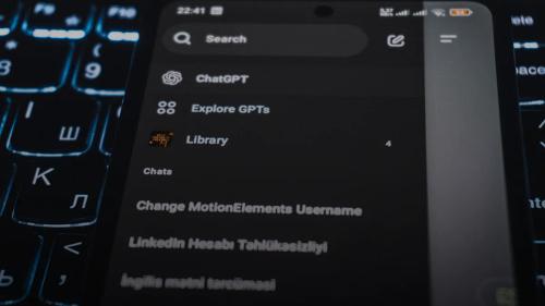 Smartphone screen displaying chatgpt interface on keyboard