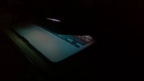 a laptop computer lit up in the dark