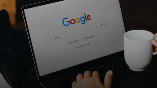 A person sitting in front of a laptop computer