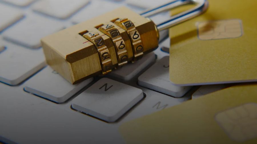 a golden padlock sitting on top of a keyboard