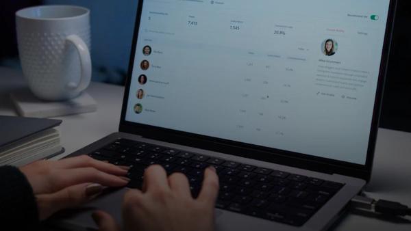 a person typing on a laptop computer on a desk