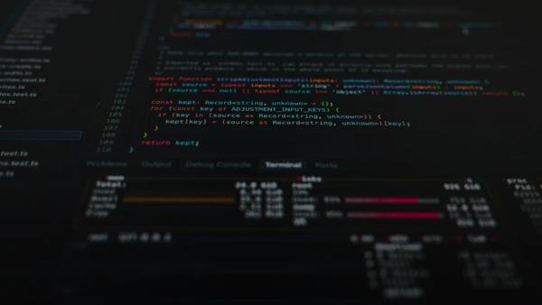 Computer code displayed on a dark screen with a terminal window showing system metrics