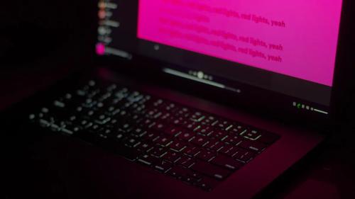 a close up of a laptop with a pink screen